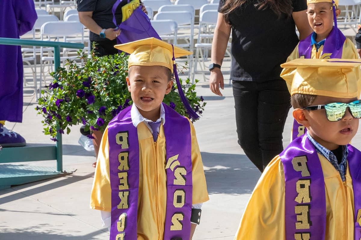 A pre-k San Juan College CFDC student in graduation attire